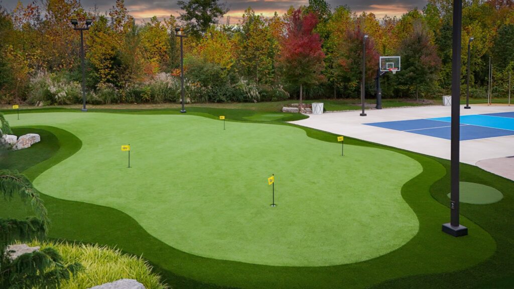 Backyard putting green in Indianapolis with multiple holes and adjacent basketball court installed by Indy Putting Greens