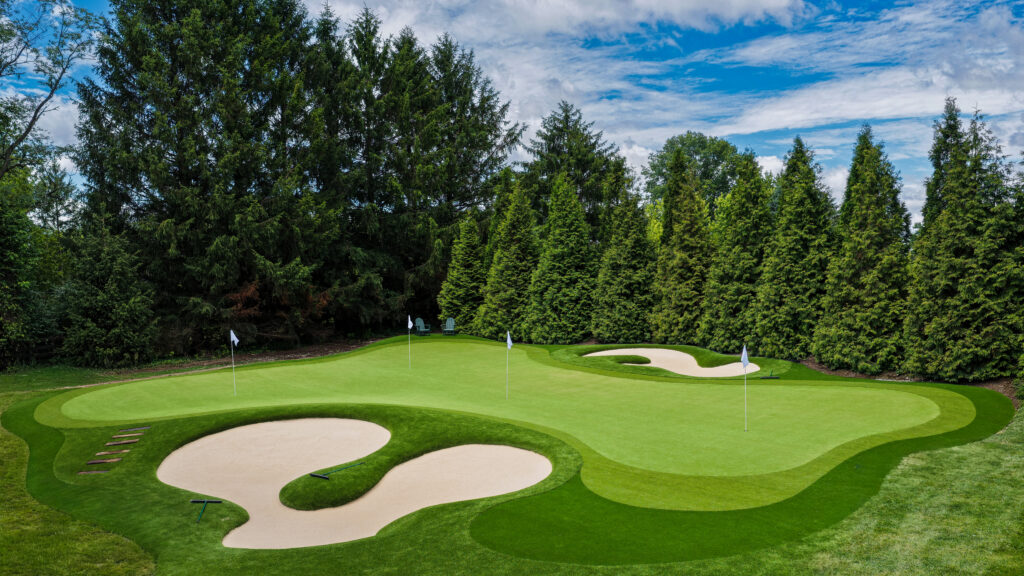 Custom backyard golf complex with rolled edge sand bunkers and multiple holes